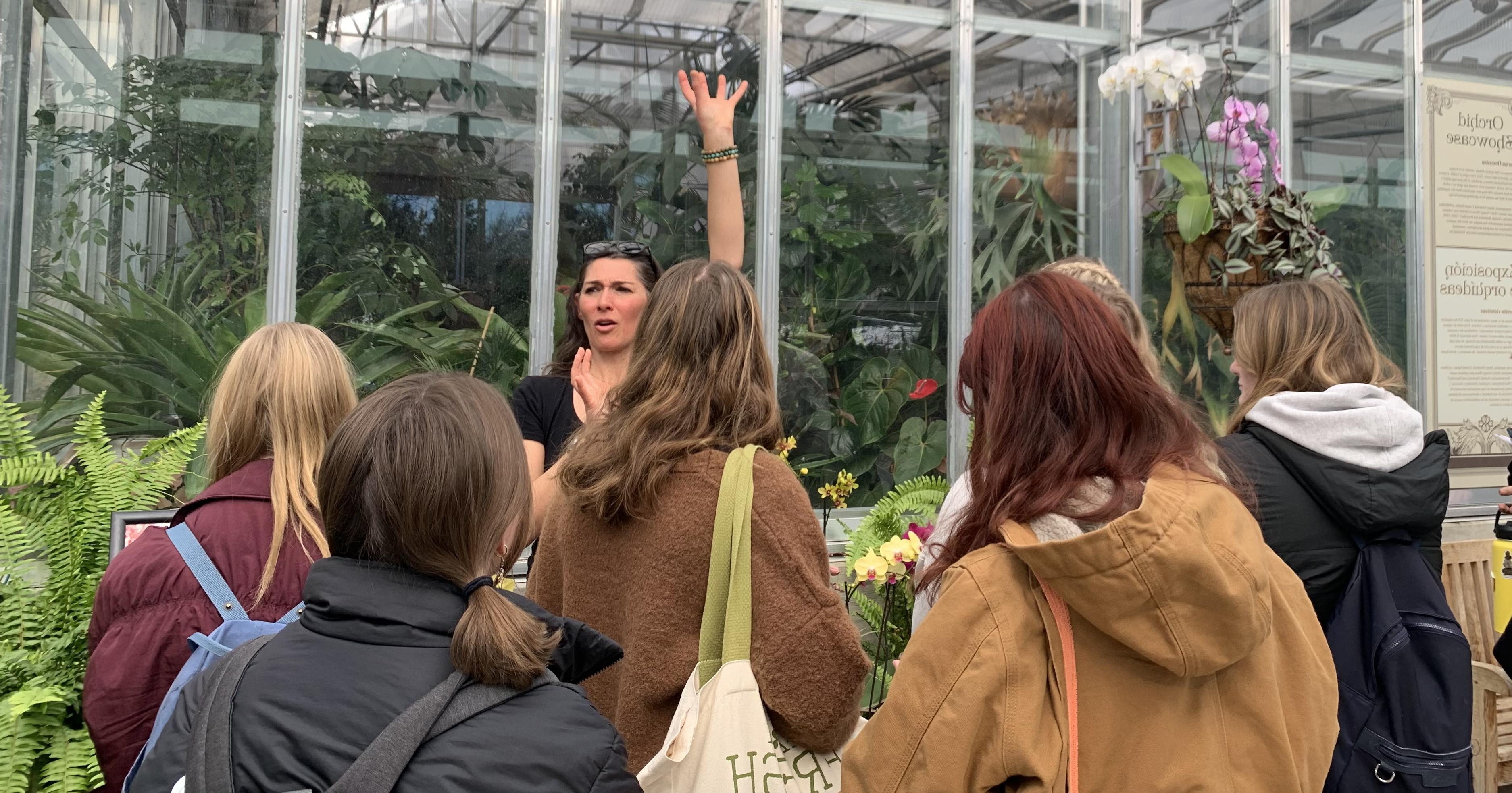 Professor Roxaneh Khorsand explaining orchid structure in a field trip with students in Biology of Plants to Denver Botanical Garden on block five.
